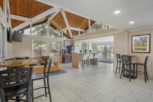a dining room and living room with tables and chairs at Best Western Gold Country Inn in Grass Valley