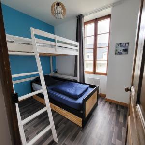 a bedroom with two bunk beds and a ladder at La Cale en Vue in Fouesnant