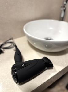a black brush sitting on a counter next to a bowl at Casa Azhuma in Granada +11 photos