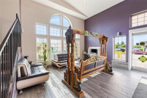 a living room with a bed and a couch at SureStay Plus Hotel by Best Western Kearney in Kearney