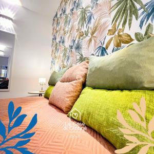 a bedroom with a bed with colorful pillows on it at Le Case di Ciccine' in Bagheria