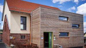 a brick house with a red roof at Bauwagen Villa Sweden in Rauenberg