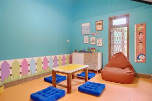 a room with a table and chairs in a room at Entire Heritage Villa Family friendly in the Center of Yogya with Swimming Pool - Up to 9 people in Yogyakarta