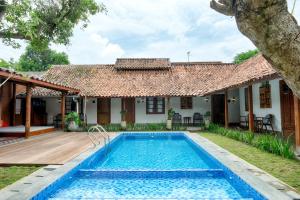 a villa with a swimming pool in front of a house at Entire Heritage Villa Family friendly in the Center of Yogya with Swimming Pool - Up to 9 people in Yogyakarta