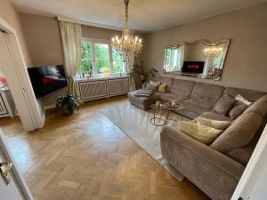 a living room with a couch and a tv at Residence Siedlinghausen in Winterberg
