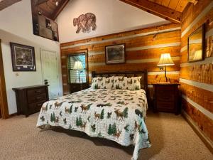 a bedroom with a bed in a room with wooden walls at Bear View in Townsend +14 photos