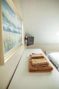 a pair of towels sitting on a table in a bedroom at An Garaiste in Rosscarbery