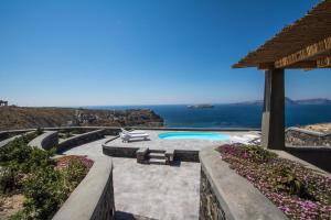 a resort with a pool and a view of the ocean at Our Villa Santorini in Akrotiri