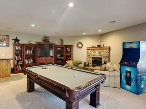 a living room with a pool table and a video game at One Ski Hill in McHenry