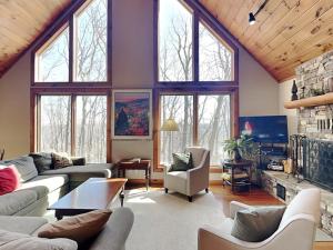 a living room with purple walls and large windows at One Ski Hill in McHenry