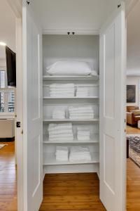 a closet with white towels and a bed at "cityscape Retreat" Condo W Balcony King Bed in Atlanta