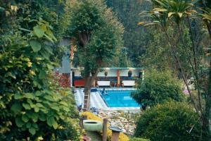 uma casa com piscina num jardim em Bunyonyi Safaris Resort em Kabale