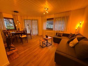 a living room with a couch and a table at Ermstalsuite in Dettingen an der Erms
