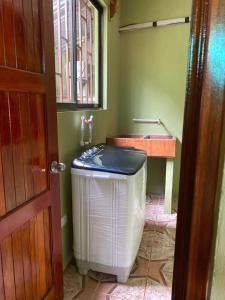 a bathroom with a heater and a sink in a room at Apartment 5 -10 minutes away BY CAR from Manuel Antonio beach! in Quepos +9 photos