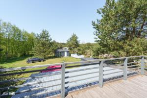 a view from the deck of a house with a car at Vasarnieki 24 in Ziemupe