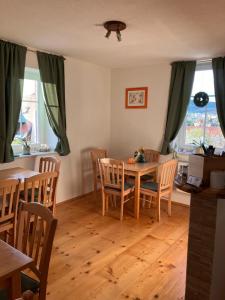 a dining room with a wooden table and chairs at Pension Maate in Český Krumlov
