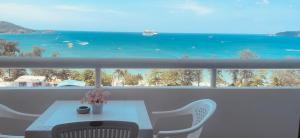 a table and chairs on a balcony with a view of the ocean at Patong Tower 2 Bedrooms Sea View Top Top in Patong Beach