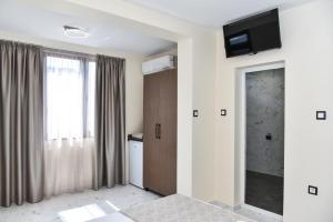 a room with a door with a television on the wall at Kaleya House in Chernomorets