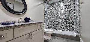 a bathroom with a black and white patterned shower curtain at Majestic Retreat in Sevierville +51 photos