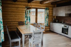 a kitchen and dining room with a table and chairs at Hawiry Nad Dylą in Głębockie Pierwsze +27 photos