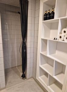 a shower with a black shower curtain in a bathroom at Bredgade 38 - Downstairs in Sønder Felding