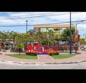 a park in front of a building with a playground at Itaipuaçu Central in Maricá
