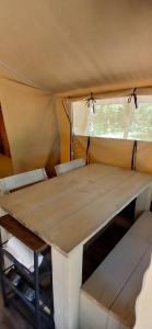 a table and chairs inside of a tent at Tente Lodge in Saint-Paul-en-Born