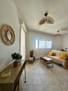 a living room with a couch and a table at Cosy Perpi Gare in Perpignan +13 photos