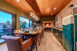 a dining room with a long table and a fireplace at Villa Oasis in Zadar