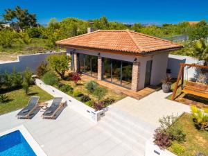 a villa with a swimming pool and a house at Villa Oasis in Zadar