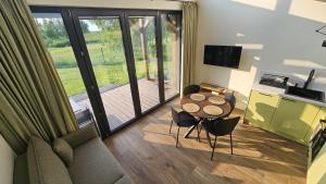 a living room with a table and a couch at Osada Mech i Fale in Tarnobrzeg