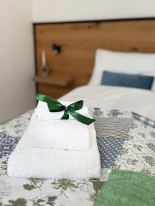 a pile of towels with a green bow on a bed at Apartment Theresa in Bad Goisern