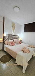 a bedroom with two beds and a chandelier at Lovely apartment in Costa Adeje by Vapagó Tenerife in Playa Fañabe