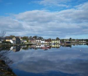 a large body of water with houses and boats at Aira Lodge Accommodation in Kinvara