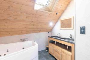 ein Badezimmer mit einer weißen Badewanne und einem Waschbecken in der Unterkunft Cabana & La Grange aux 7 Marmottes in Saint-Alban-des-Villards + 51 Fotos