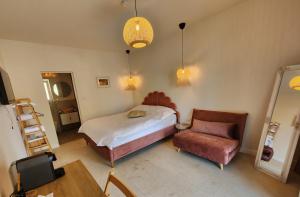 a bedroom with a bed and a chair at Eunoia in Vama Veche