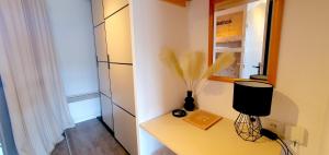 a room with a table with a vase on it at Pieds des pistes - Parking couvert - Plein sud in L'Alpe-d'Huez +59 photos