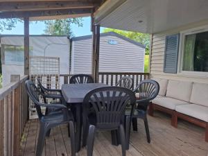a patio with a table and chairs on a deck at Lya in Nages