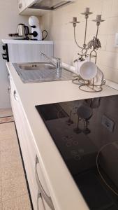 a kitchen with a sink and a counter top at Sea Vibes - Rome in Lido di Ostia +9 photos