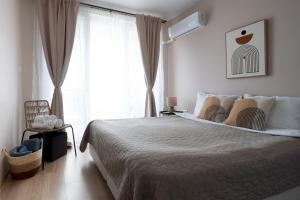 Ένα ή περισσότερα κρεβάτια σε δωμάτιο στο Boho Apartment Sozopol