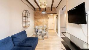 a living room with a blue couch and a table at Seaview Villa in Apollonii Lefkada in Athanion