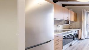 a kitchen with white cabinets and a sink and a stove at Seaview Villa in Apollonii Lefkada in Athanion +3 photos