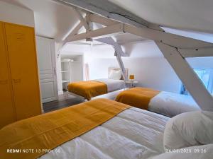 Postel nebo postele na pokoji v ubytování Le Gîte des Capucines