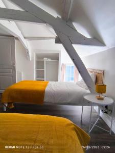 Postel nebo postele na pokoji v ubytování Le Gîte des Capucines