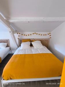 Postel nebo postele na pokoji v ubytování Le Gîte des Capucines