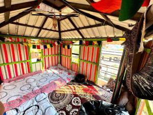 a room with a bed in the inside of a bus at Whereabout Hostel Udaipur in Udaipur