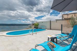 a patio with two chairs and a swimming pool at House Mimica in Stanići