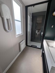 a bathroom with a large mirror and a sink at Camping de Lanven in Plomeur