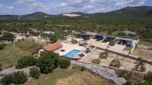 an aerial view of a house with a swimming pool at Mobile home Banovi dvori III in Tisno