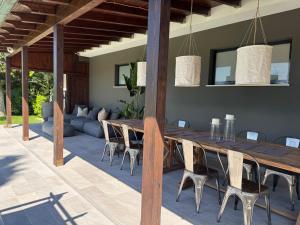 a dining room with a long wooden table and chairs at Villa Torrione - Apartments & Pool in Civitanova Marche